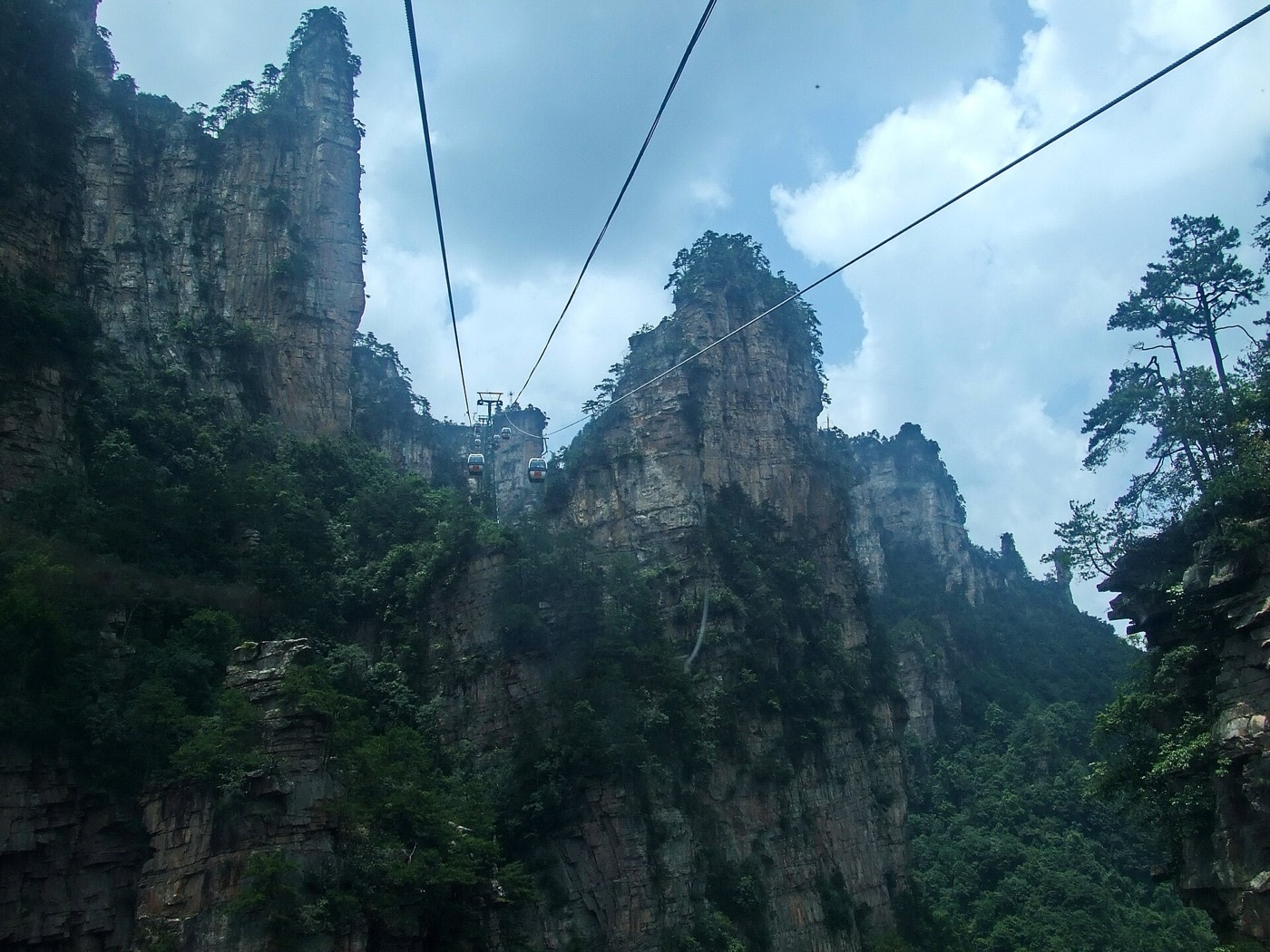 Gondolas of the Tianzi Mountain cableway travelling between towering sandstone cliffs
